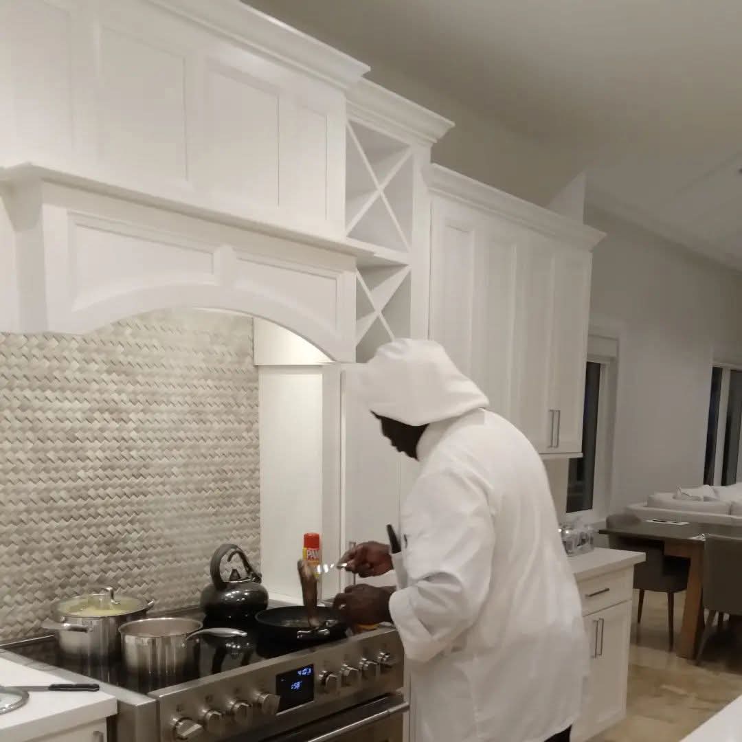 Chef Julian searing a dish on the stovetop while cooking a private dinner