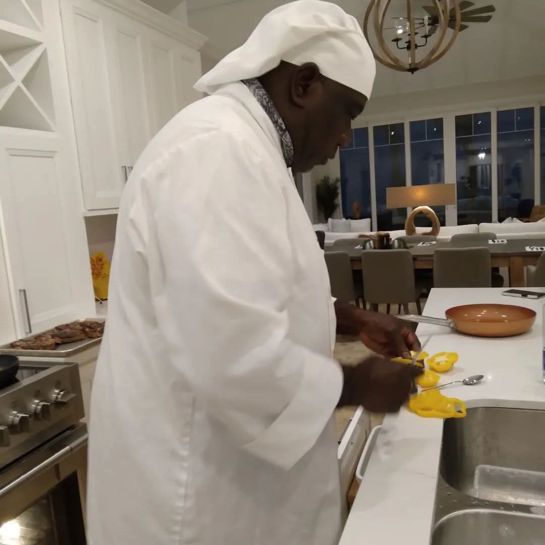 Chef Julian slicing fresh yellow peppers in a bright island kitchen