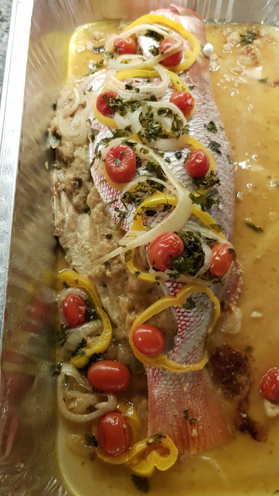 Whole baked snapper with peppers, onions and cherry tomatoes