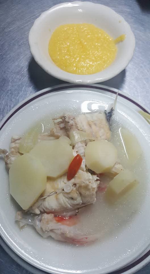 Traditional boil fish with potatoes and a side of grits
