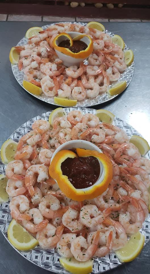 Chilled shrimp cocktail platters with lemon and cocktail sauce