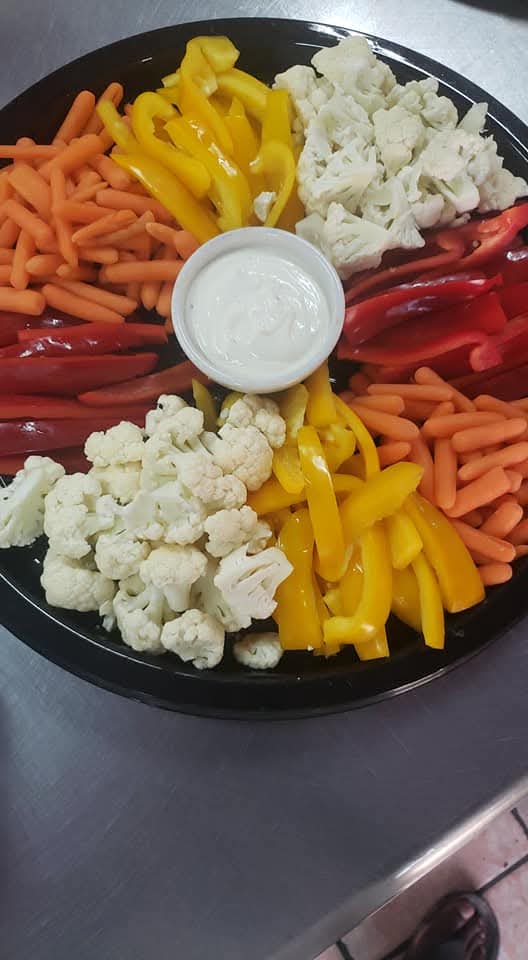 Fresh vegetable platter with carrots, peppers, cauliflower and dip